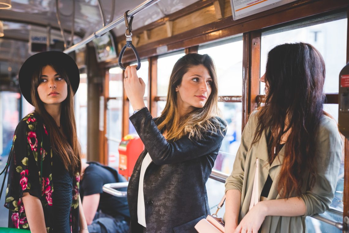 Three young women travelling on city tram