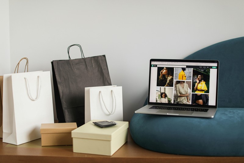 A laptop screen shows a 3D model marketplace website with a 3D model of a dragon being viewed.