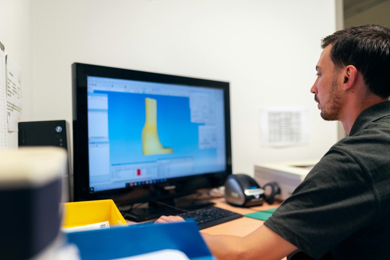 A software interface for 3D model repair shows a mesh with fixed errors and a repaired model displayed in the foreground.
