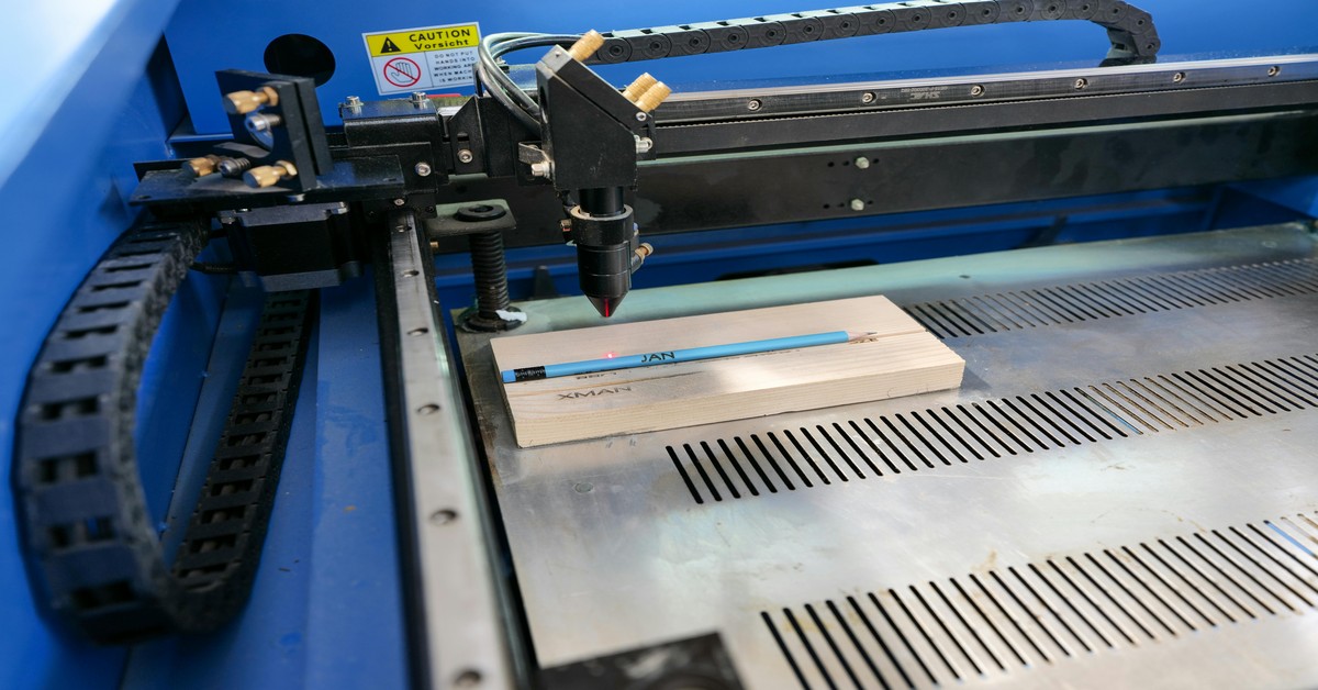 A 3D printer enclosed in a fireproof fabric tent on a work desk
