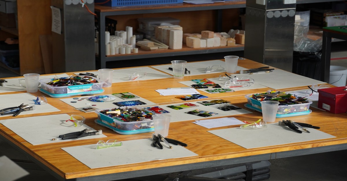 A 3D printer kit spread out on a workbench showing all components before assembly