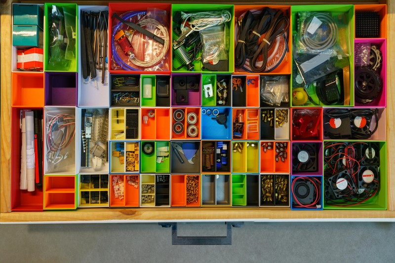 Assorted 3D printing tools and accessories organized on a desk