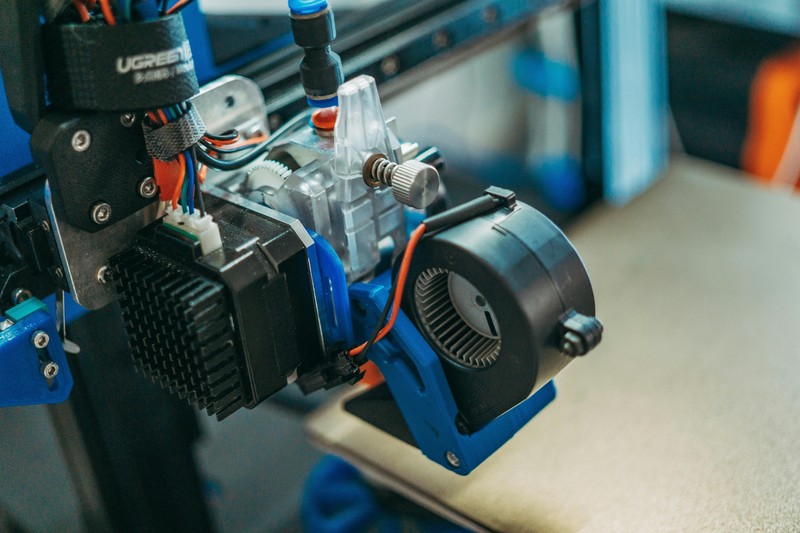 Creality Ender 3 V3 SE 3D printer in the middle of printing a detailed plastic object.
