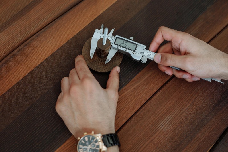 A digital caliper being used to measure the dimensions of a 3D printed object