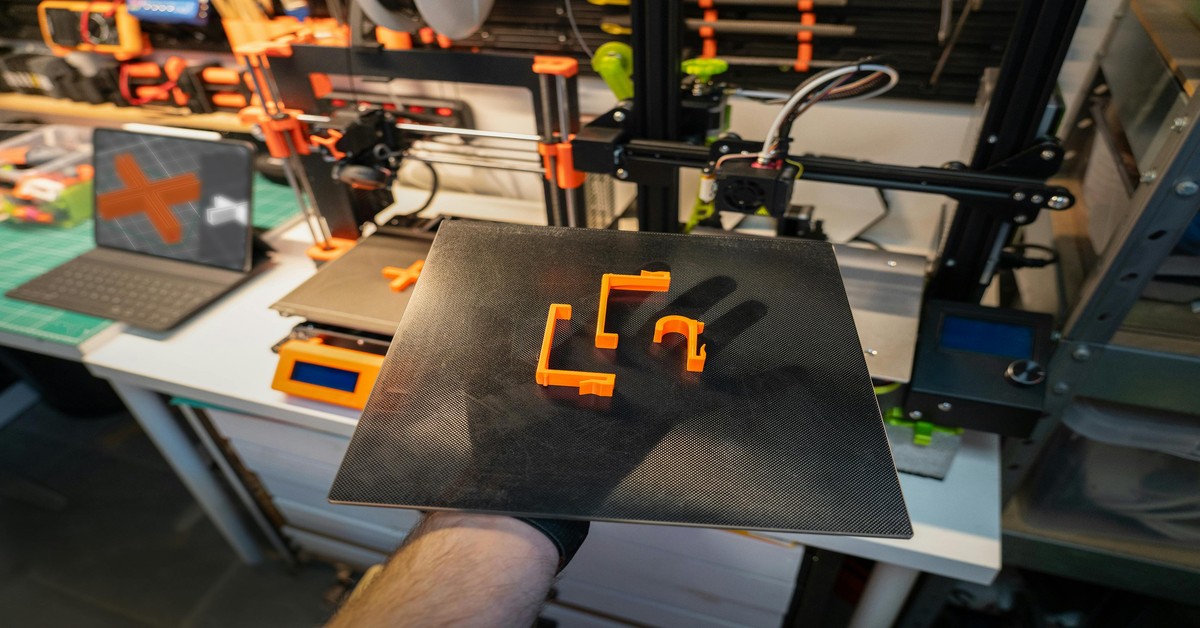 Close-up of a strong 3D printed bracket showing visible layer lines and thick walls