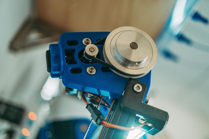 Close-up of a 3D printed nylon gear part with visible layer lines, showing strength and finish