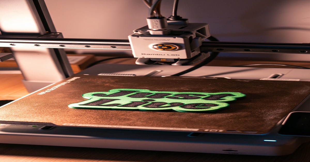 Close-up of a spool of nylon filament on a 3D printer, showing the matte surface and color