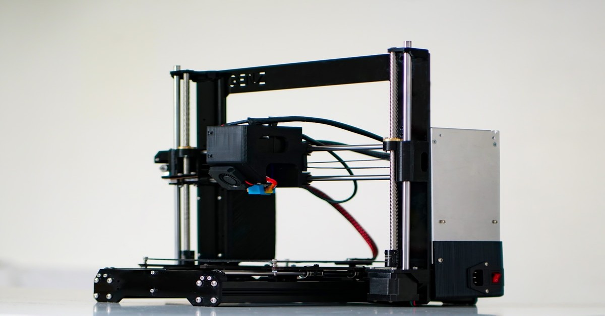 Professional 3D printer printing a detailed prototype part with precision layer lines visible