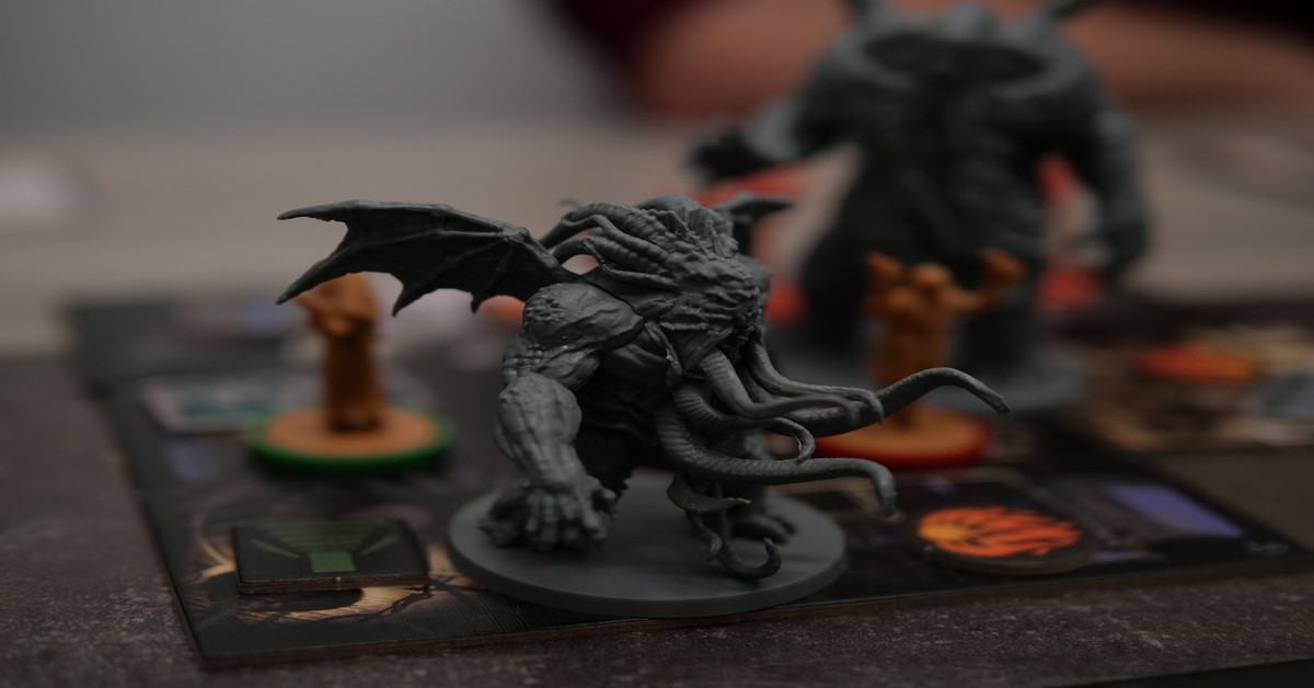 Close-up comparison of a resin printed miniature and an FDM printed miniature showing detail difference