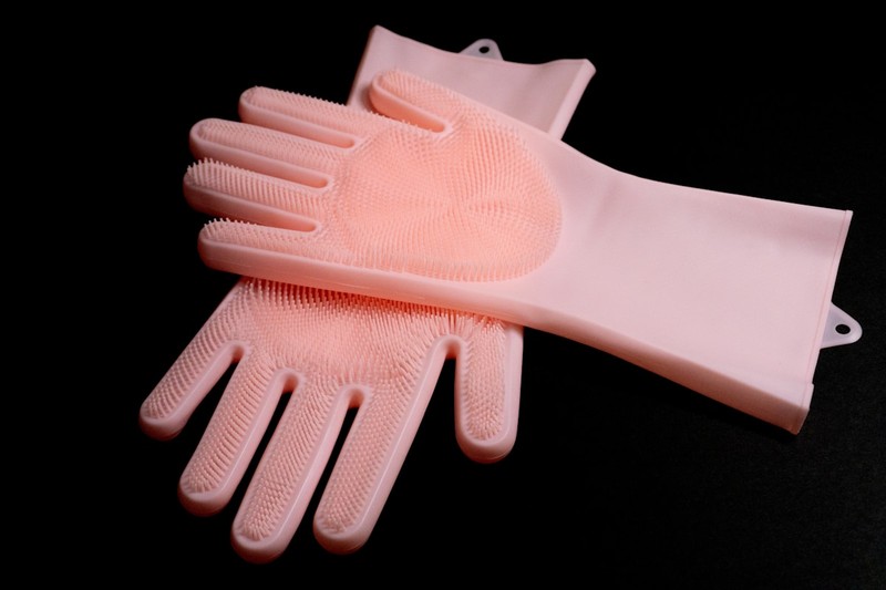 Resin printing accessories including nitrile gloves, funnels, and a silicone mat arranged on a table.