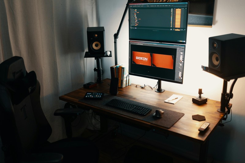 A standing desk setup with a 3D printer and computer monitor for design work